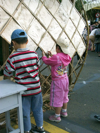 Children Writing on Handmade Paper Walls of the House