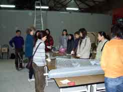 Jane talking to volunteers about making paper house lanters