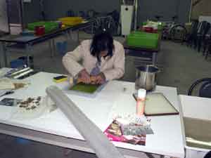 Wendy working on a paper piece