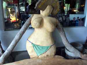 wooden women with bikini bottom held together with a "Hello Kitty" strap