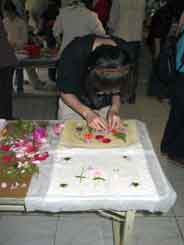 Student putting flowers on her paper