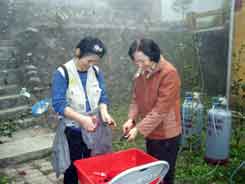 volunteers cutting fiber outdoors in the mist