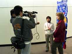 Jane being interviewed by two TV reporters