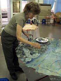 Jane painting on round site map