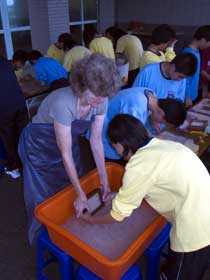Jane helping a student make paper