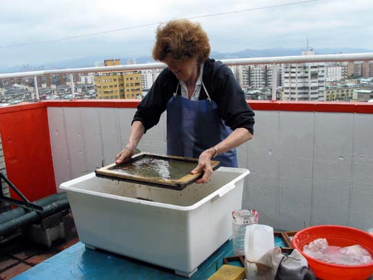 Jane making on our  roof top patio in Taiwan